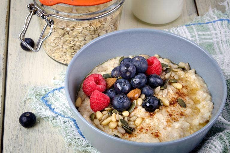Oatmeal topped with a vibrant mix of berries, nuts, and seeds